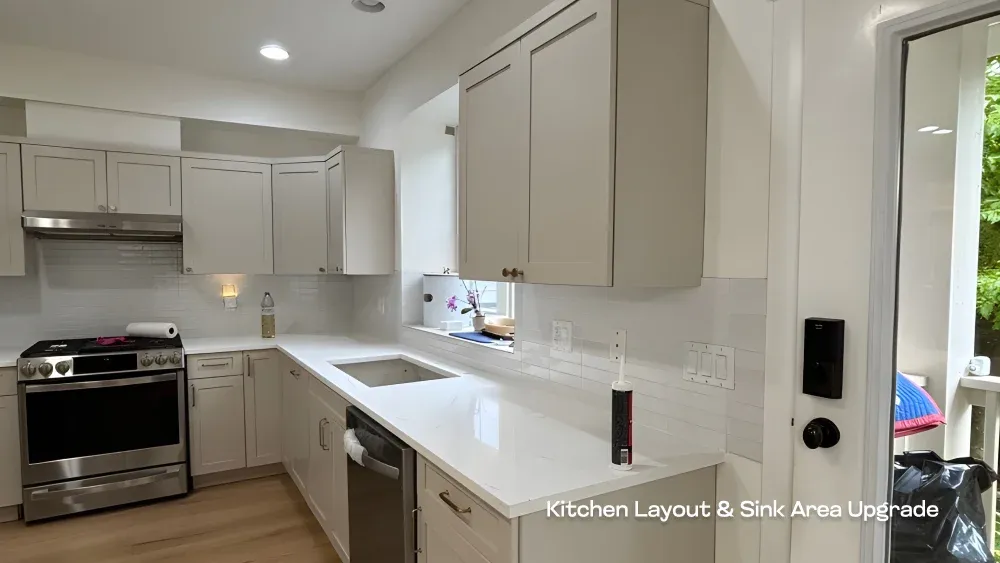 Bright, open kitchen layout featuring a new undermount sink and white quartz countertops by PCC Renovations.
