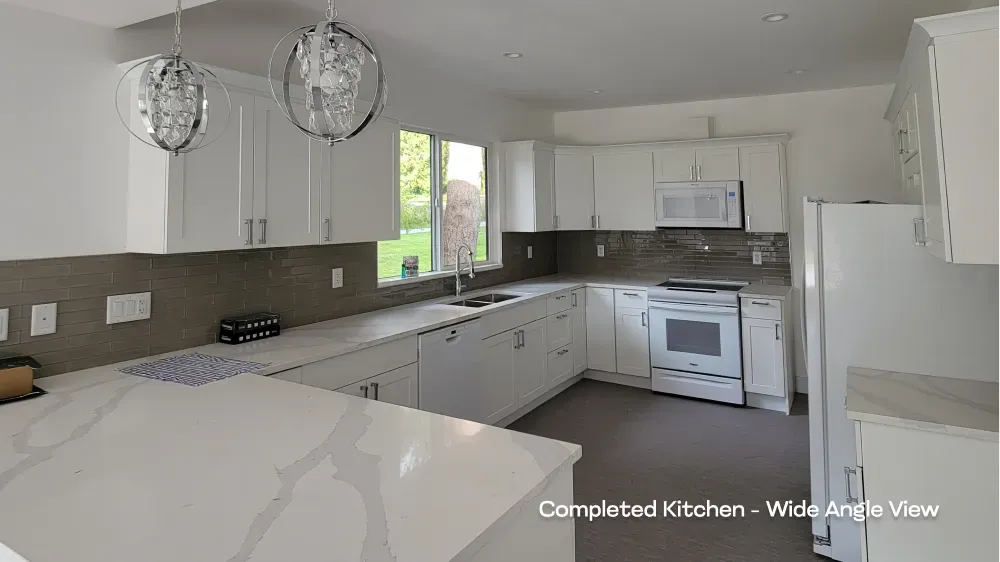 Complete residential kitchen renovation showcasing white shaker cabinetry, quartz countertops, and a grey tile backsplash by PCC. — after