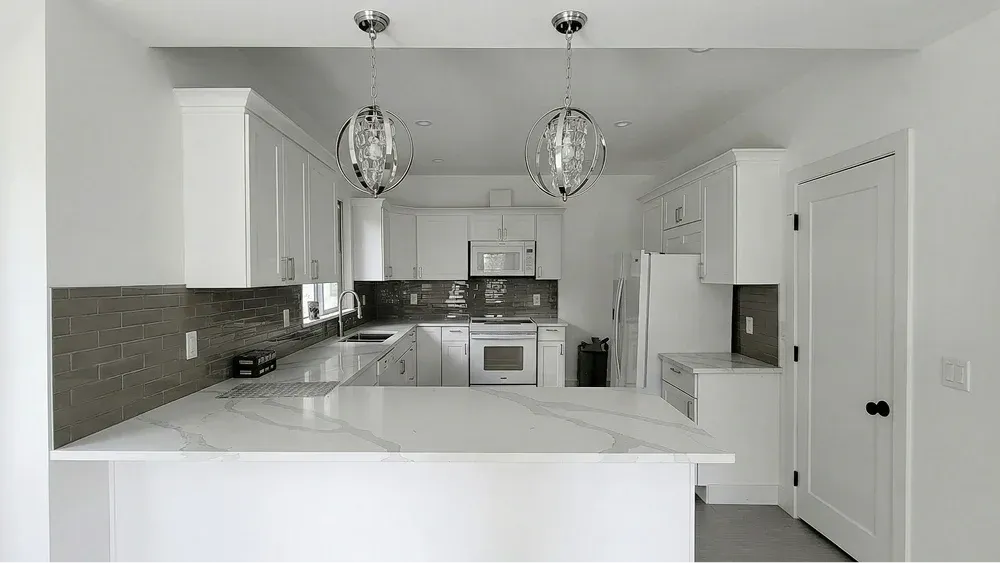Seamless, modernized kitchen workspace ready for move-in, designed with a large custom island and sleek quartz surfaces.